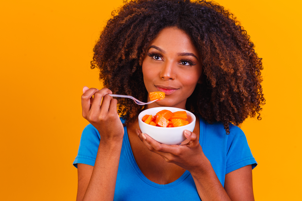 woman eating papaya