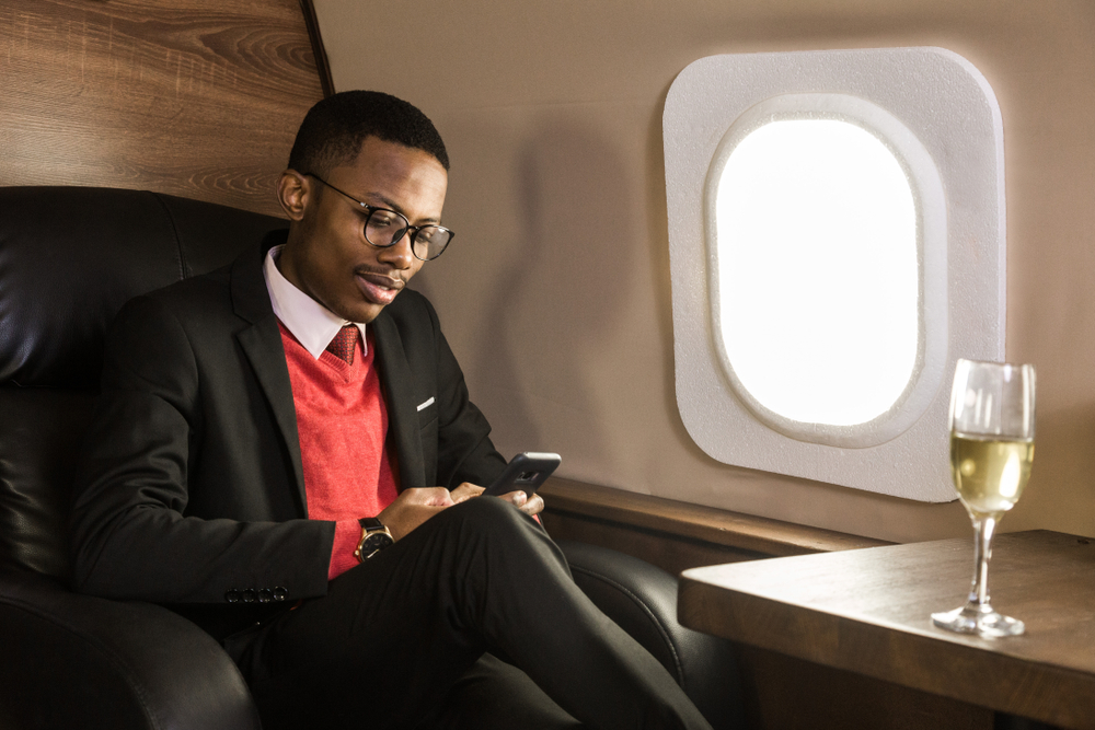 man in first class drinking alcohol